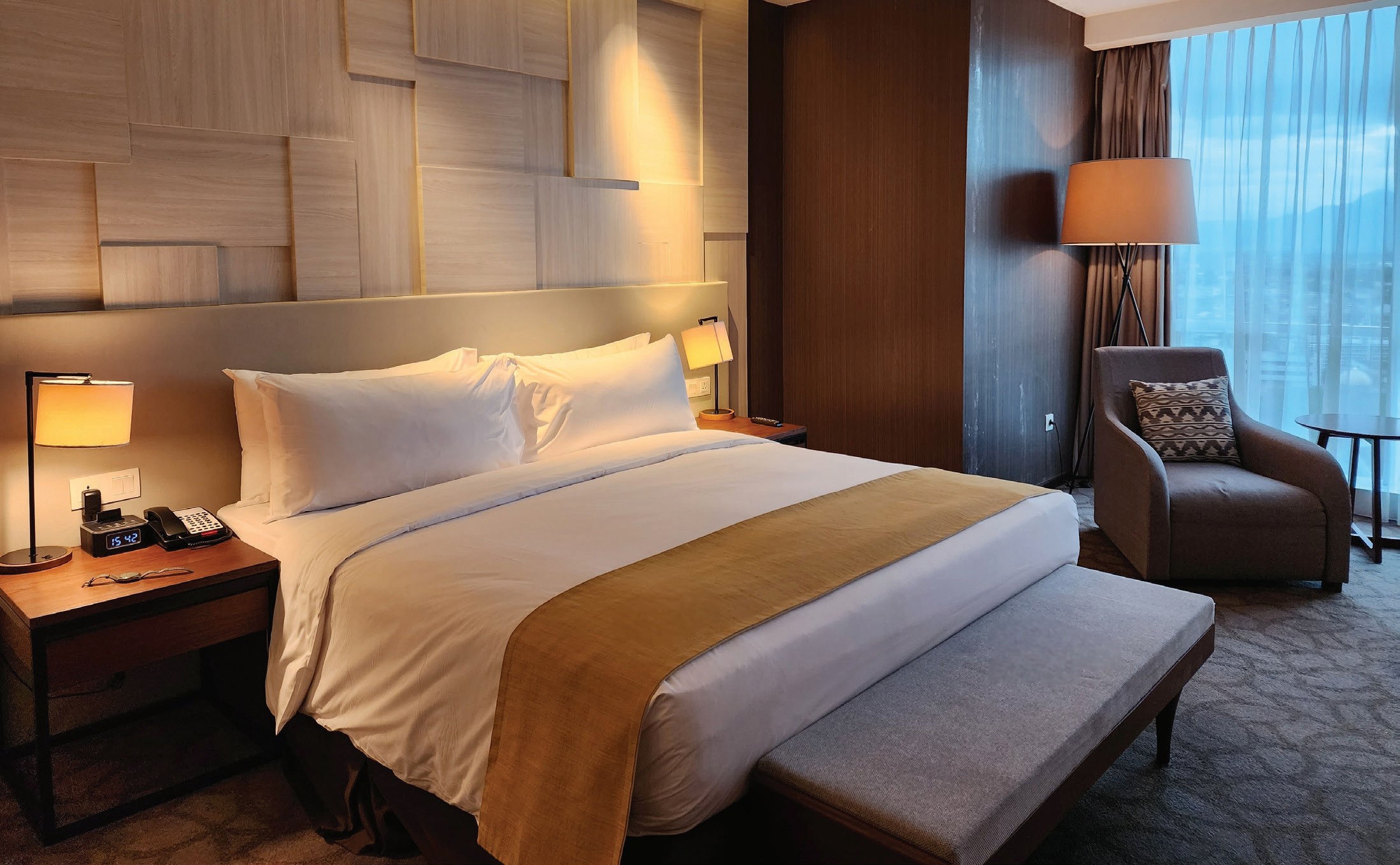 Bright hotel room with warm timber finishes
