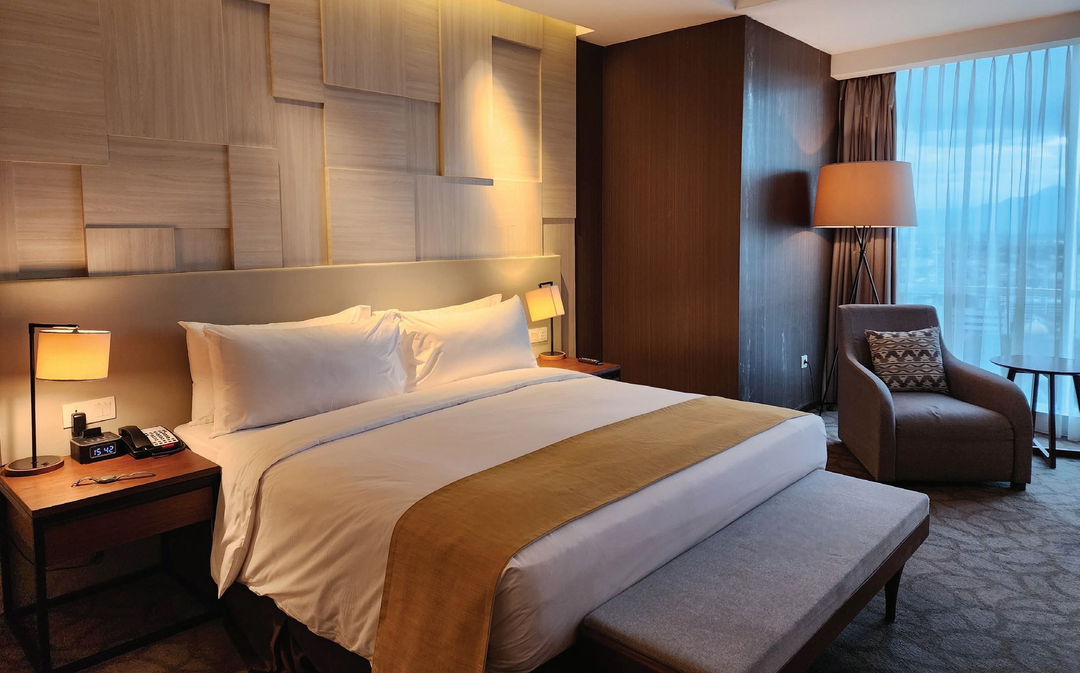 Contemporary Manchester hotel room with warm timber finishes