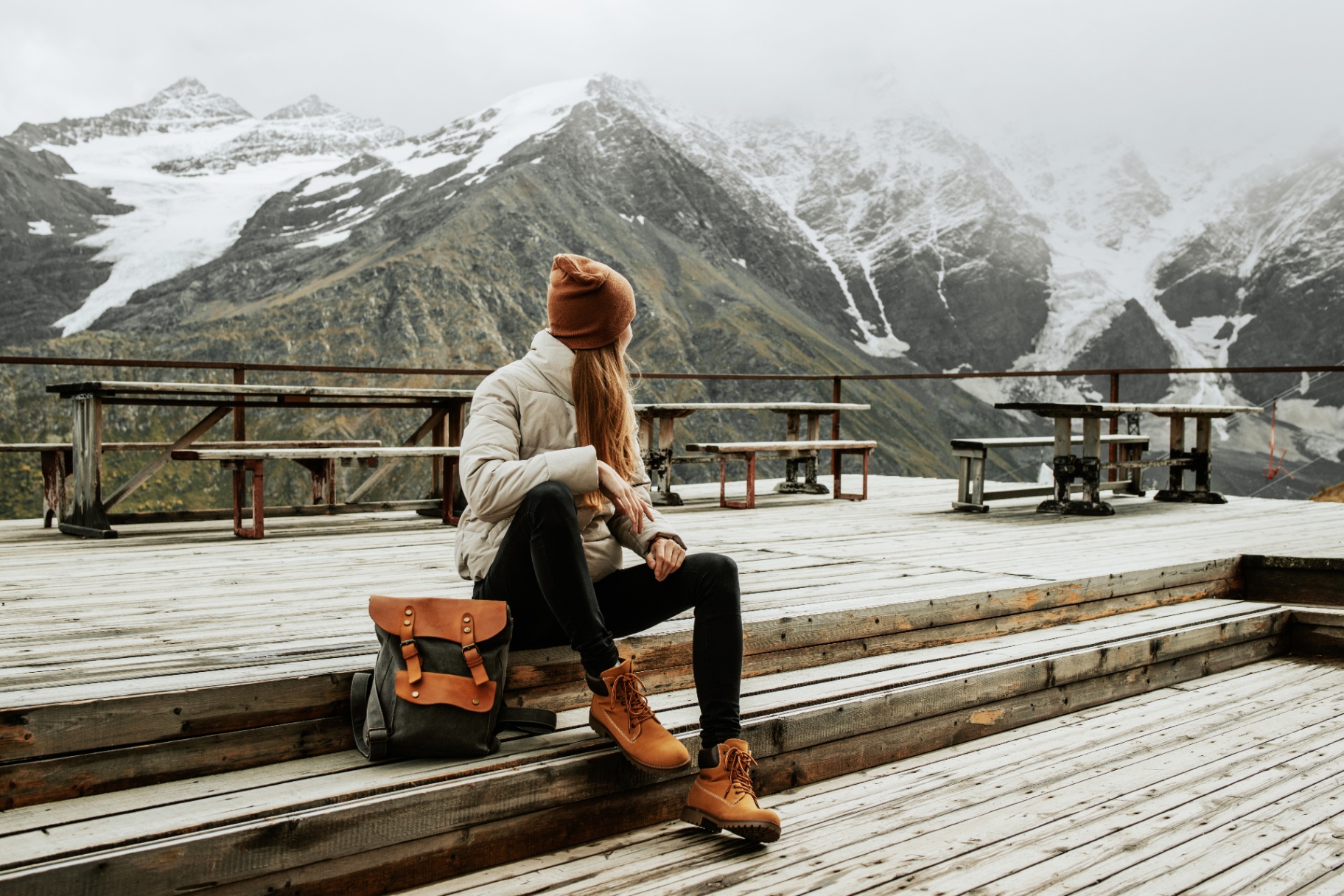 Traveler overlooking snow-capped mountains
