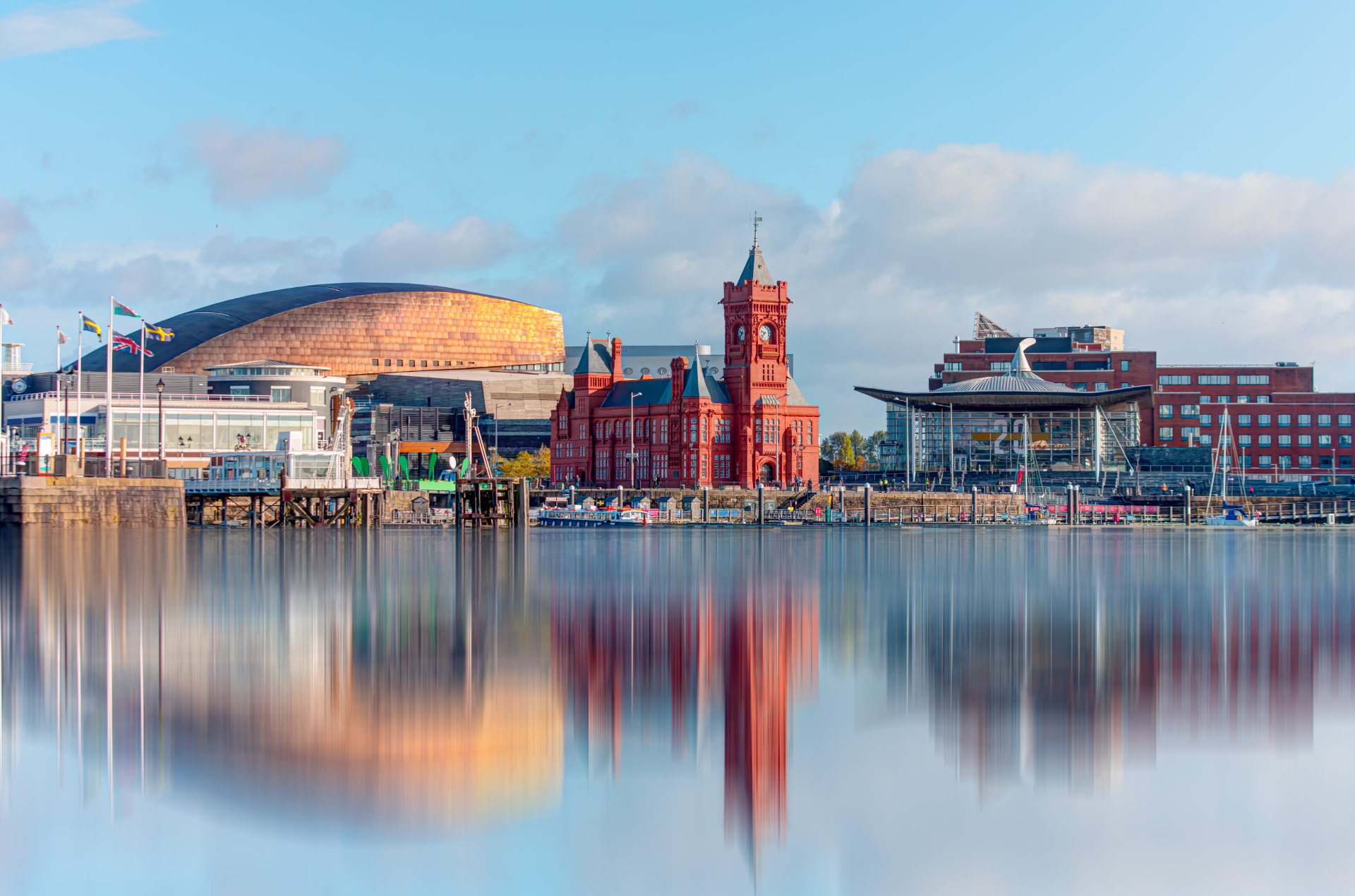 Cardiff Bay waterfront with the Wales Millennium Centre and Pierhead Building reflected in the water