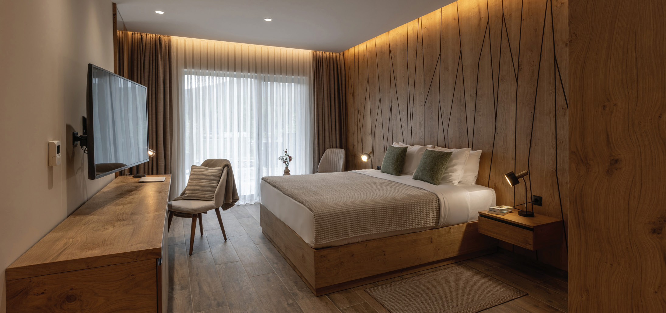 Contemporary hotel room with warm wood finishes